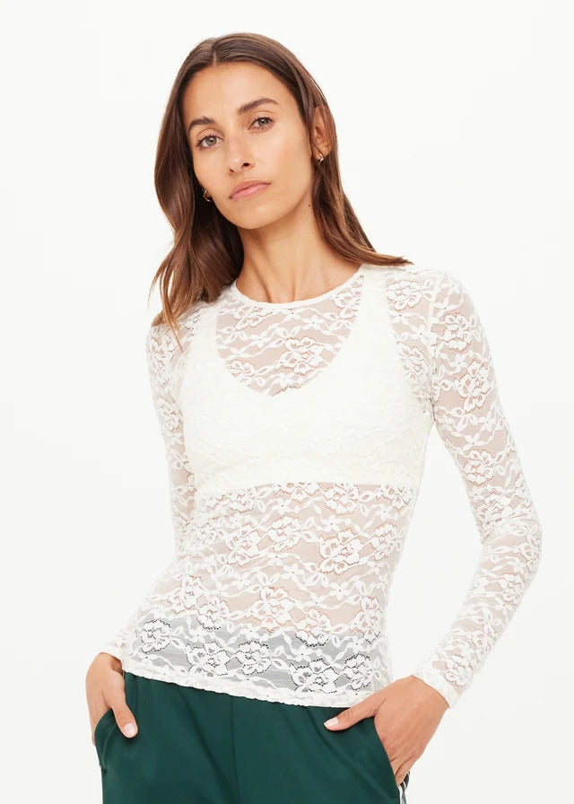 Woman wearing a white lace long-sleeve top