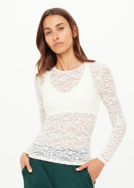 Woman wearing a white lace long-sleeve top