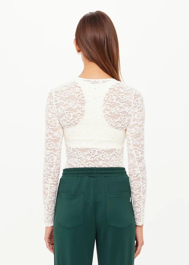 Woman wearing a white lace long-sleeve top