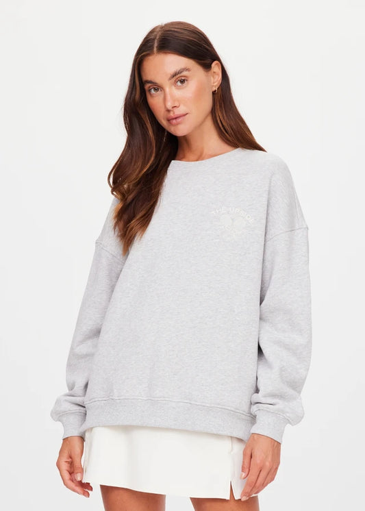 Grey marble crew sweater paired with white skirt, cotton-blend, shown on woman against a plain white background.