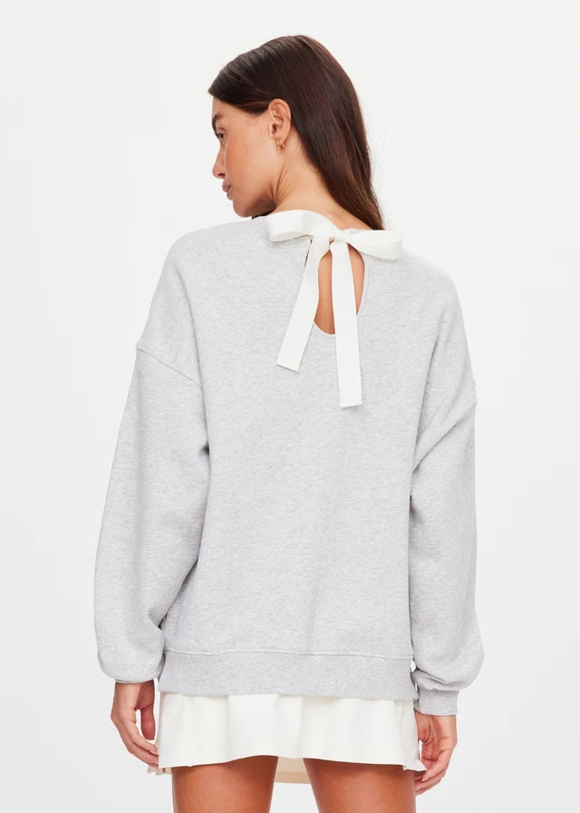 Grey marble crew sweater with a white back bow, shown from behind to display style and detail.