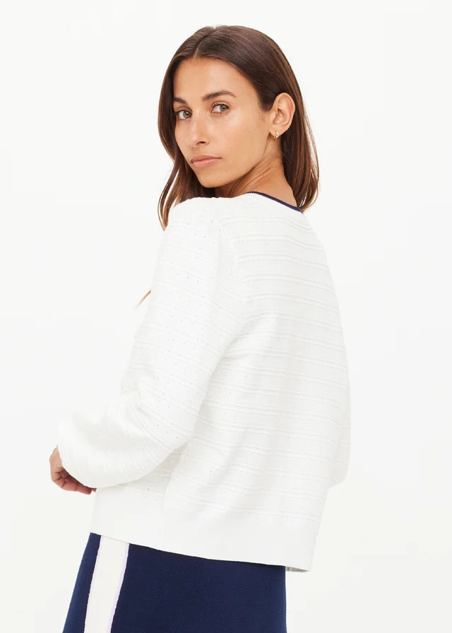 Woman wearing a white cardigan