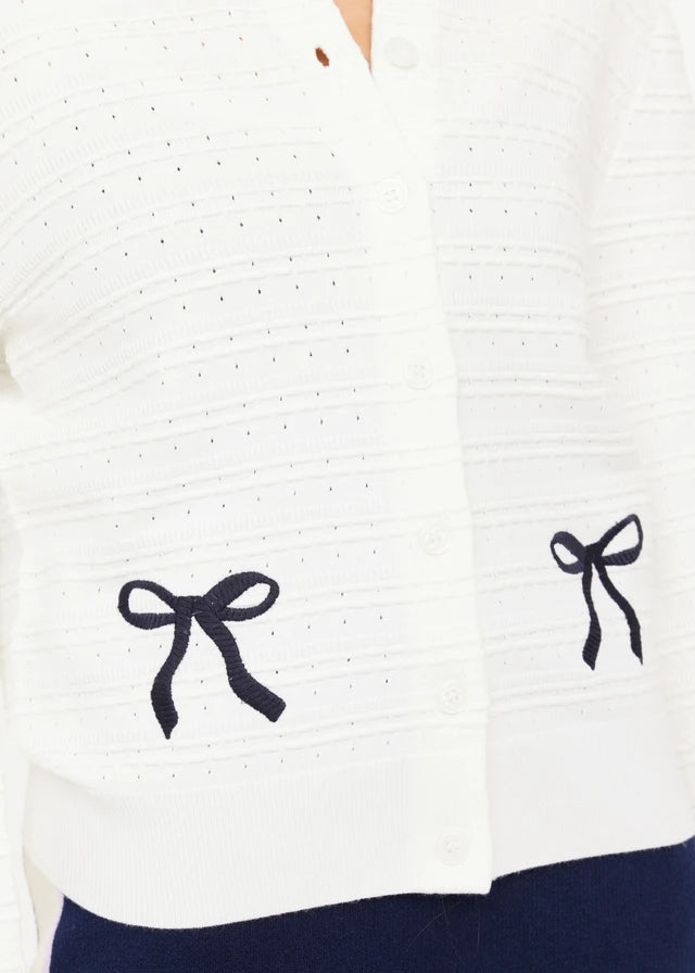 White cardigan with black bow details 