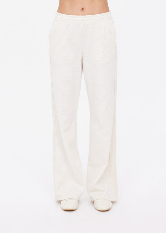 Cream wide-leg pants paired with matching shoes, crafted from light fabric, displayed against a white background.