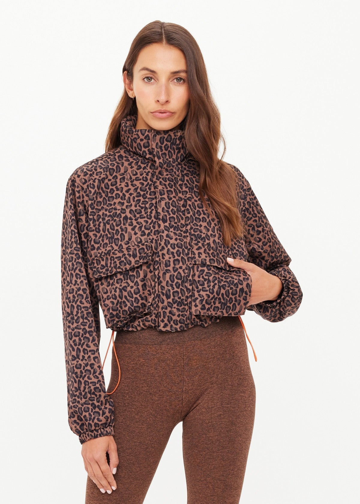 Woman wearing a leopard jacket with orange drawstrings 