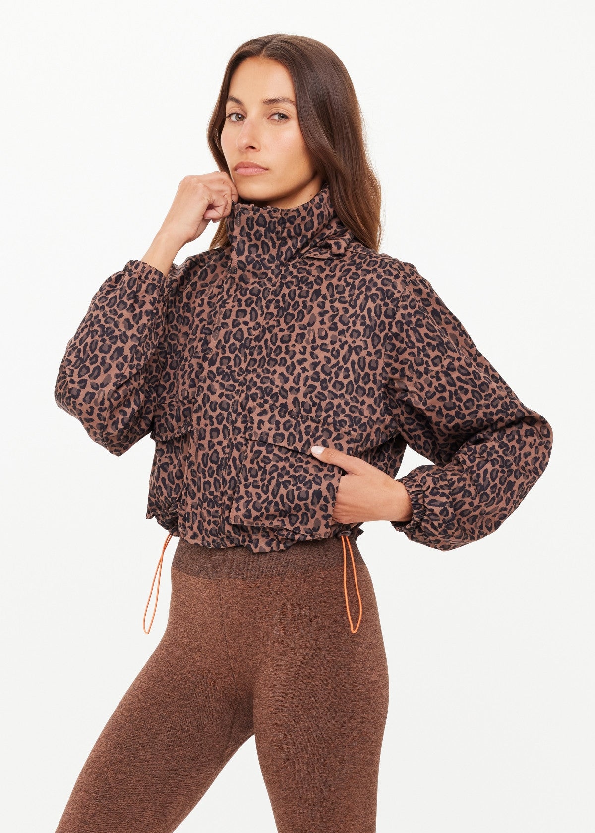 Woman wearing a leopard jacket with orange drawstrings 