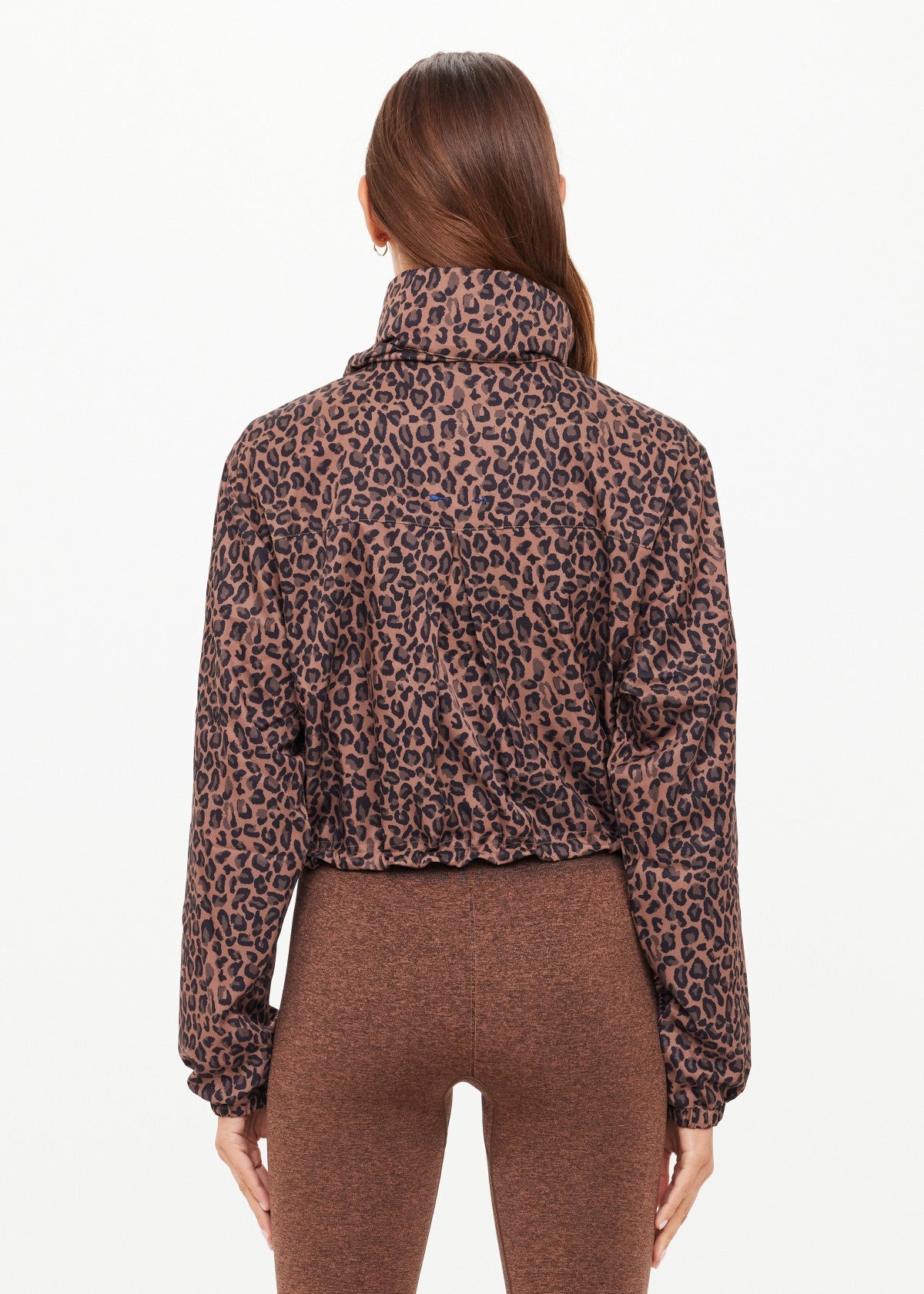 Woman wearing a leopard jacket with orange drawstrings 