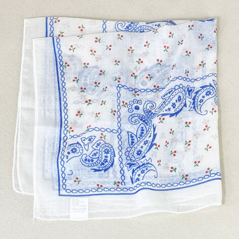 White cotton bandana folded to display floral and paisley print, suitable for headwear or accessory use.