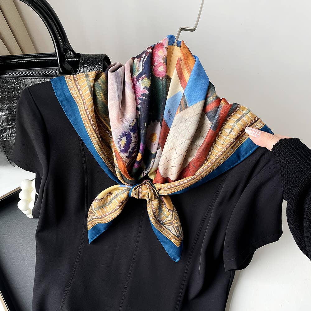 Paisley patchwork bandana tied around the collar of a black dress on a hanger. Cotton accessory shown in use.
