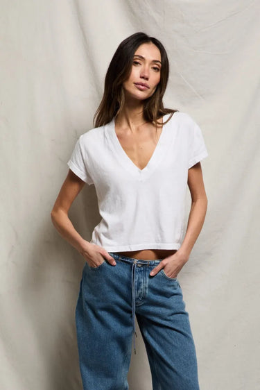 Woman in white v neck tee