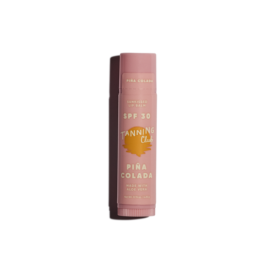 Pink SPF 30 lip balm tube with gold text, upright on a white background, designed for sun protection.