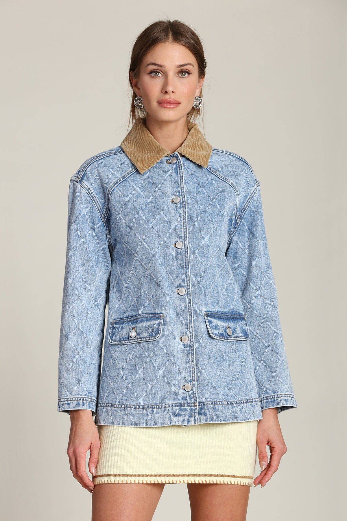 Denim barn jacket with tan collar worn over a cream mini skirt, shown as casual outerwear.
