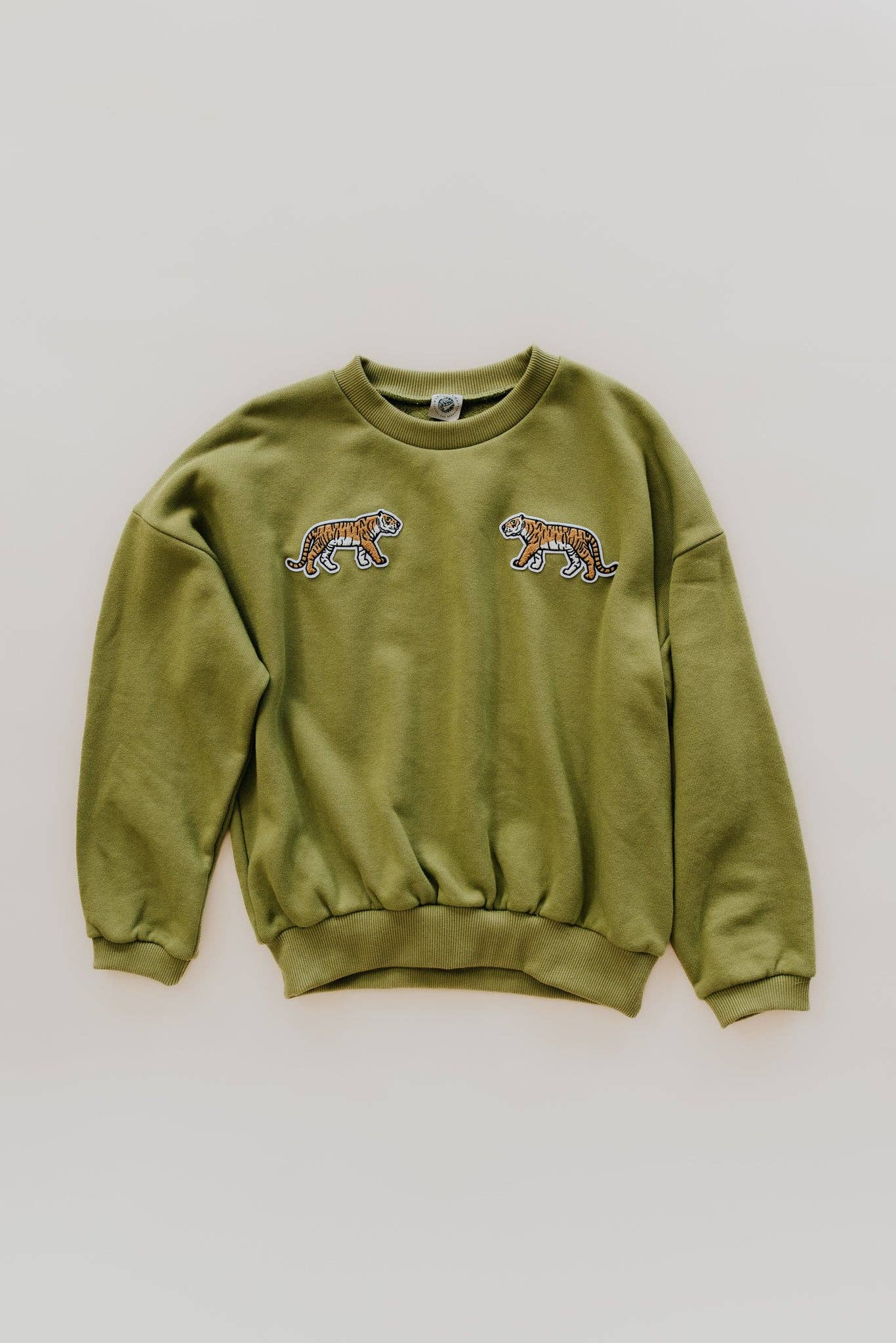 Green cotton sweatshirt with two tiger patches facing each other on the chest, displayed flat.