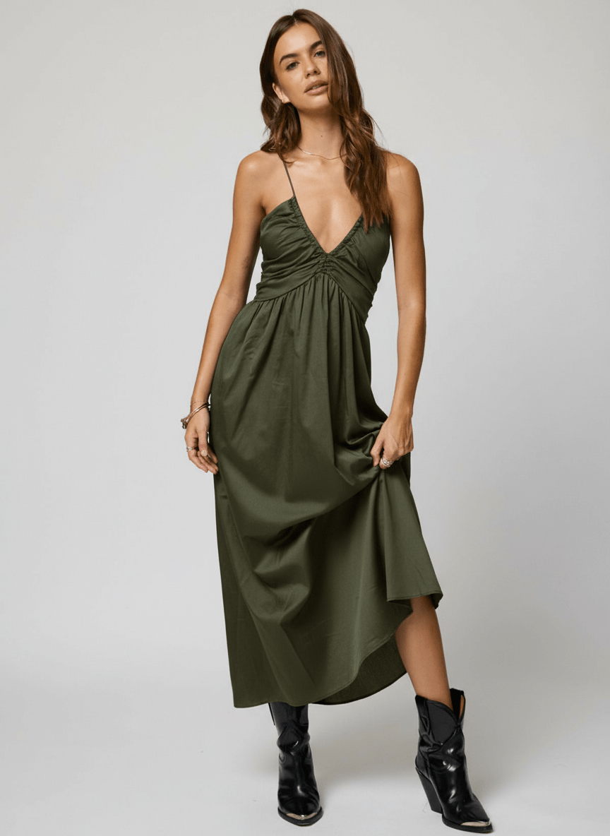 Woman wearing a green dress with black boots 