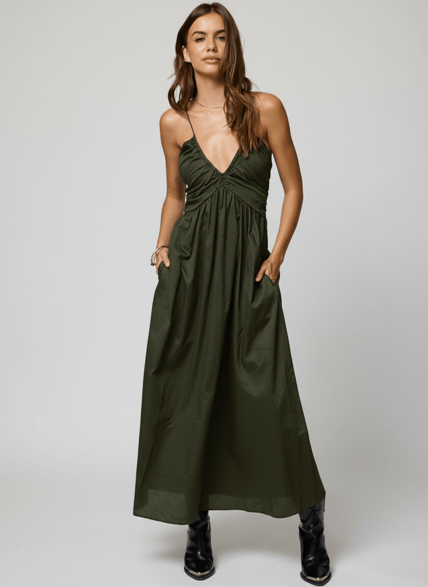 Woman wearing a green dress with black boots 