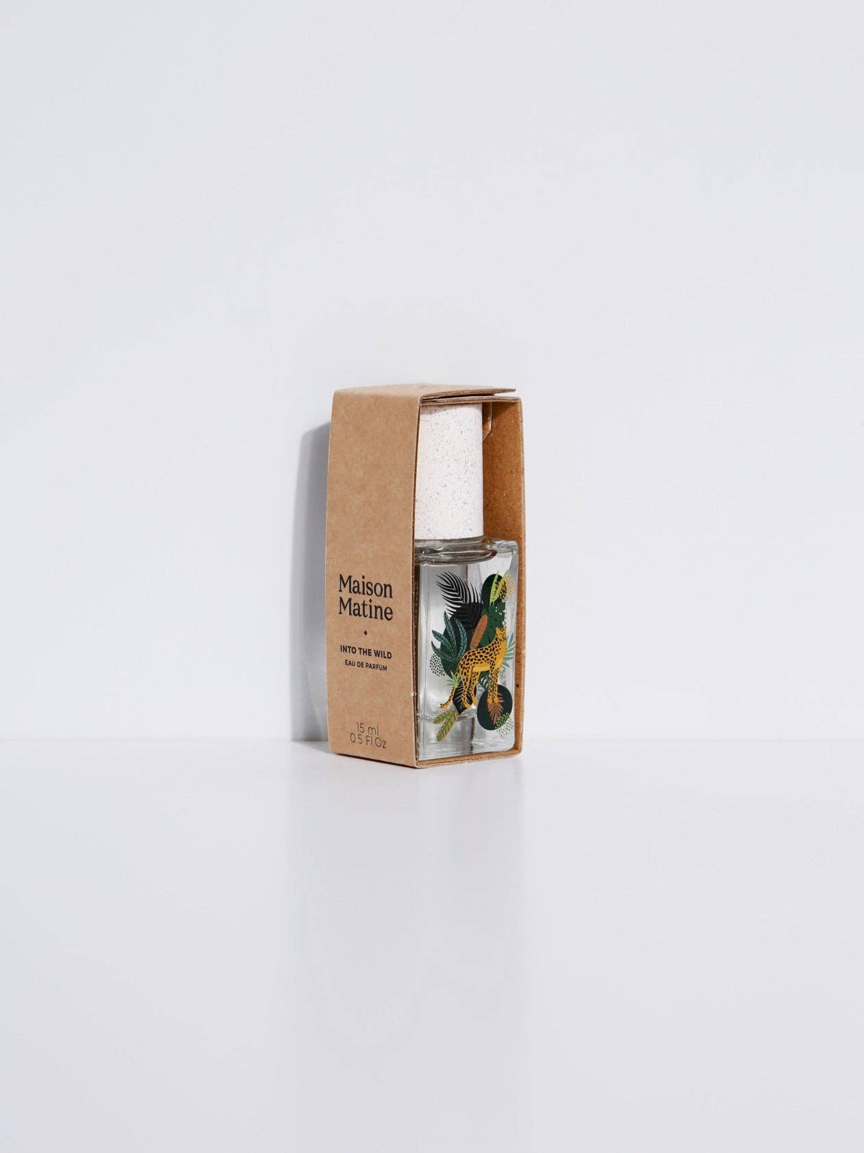 15ml clear glass perfume bottle with woody, spicy scent, packaged in a floral-printed box. Suitable for personal fragrance use.
