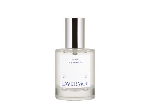 Clear glass perfume bottle with silver cap, displayed on a white background. Used for holding fine fragrance.