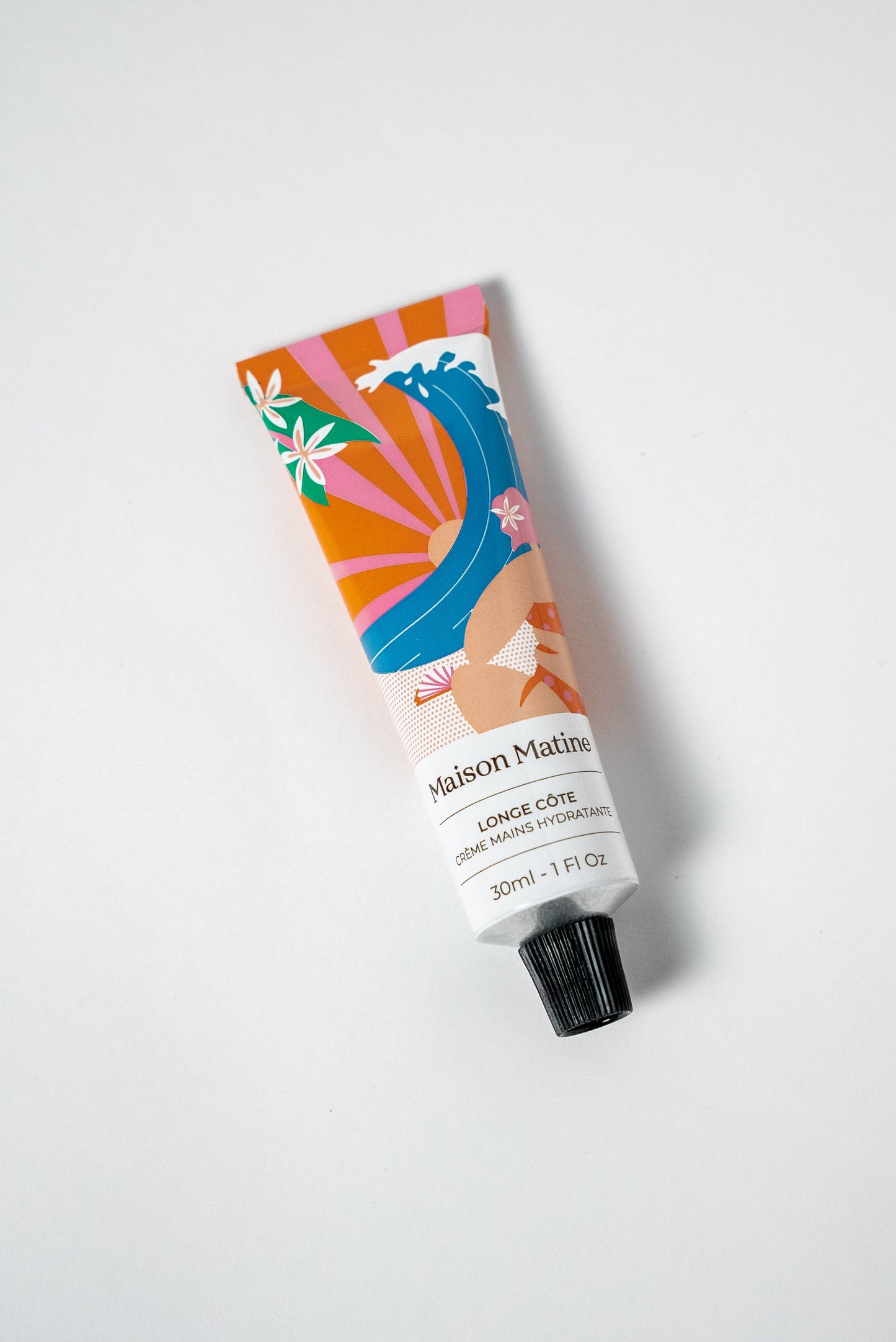 30ml white tube of hand cream with abstract artwork and black cap, designed for moisturizing hands.