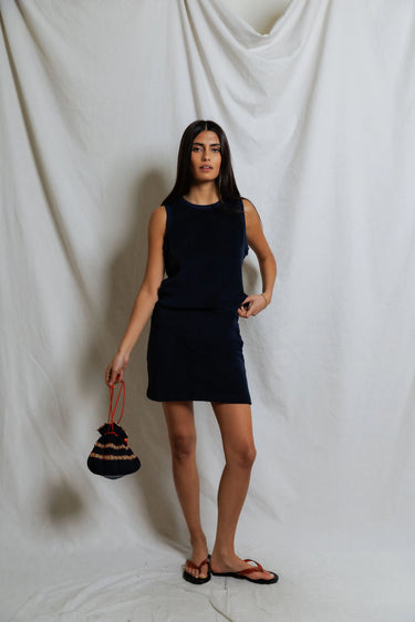 Woman wearing a navy terry elastic waist mini skirt