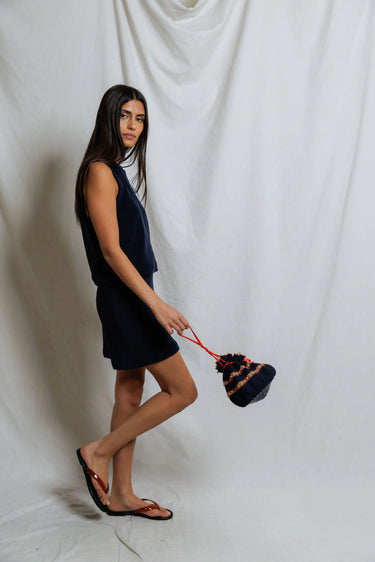 Woman wearing a navy terry elastic waist mini skirt