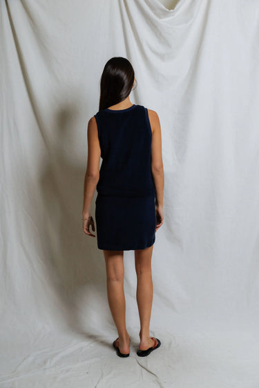 Woman wearing a navy terry elastic waist mini skirt