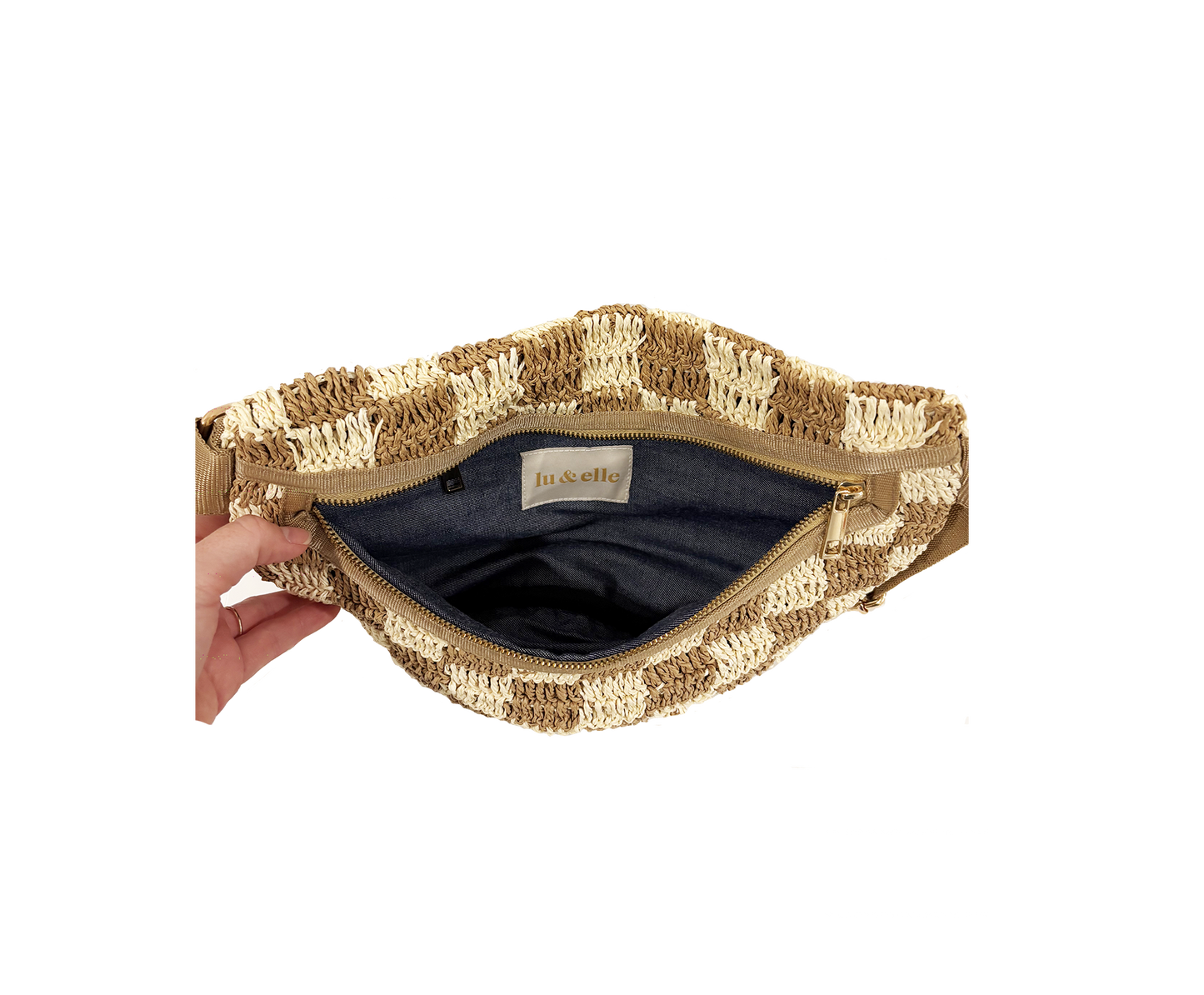 Open checkered fabric sling bag with visible striped lining and inner label, shown held in hand for size reference.