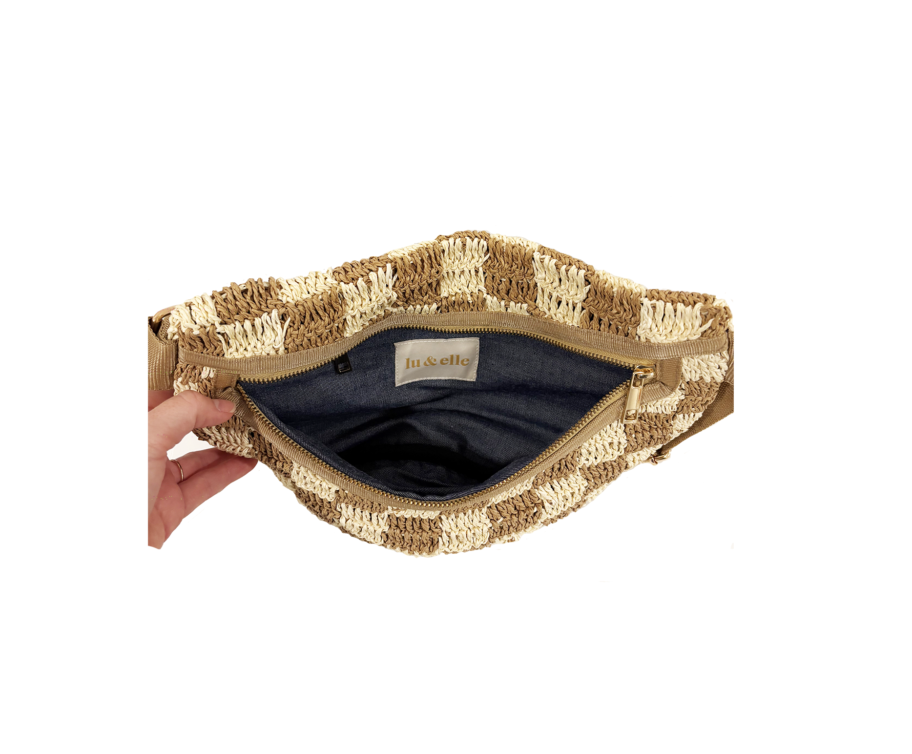 Open checkered fabric sling bag with visible striped lining and inner label, shown held in hand for size reference.