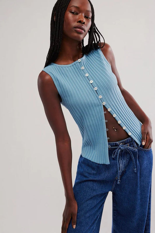 Woman wearing a light blue ribbed tank top with button details