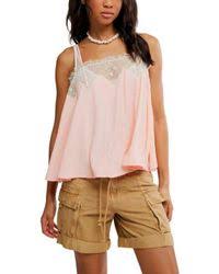 Woman wearing a light pink sleeveless top 