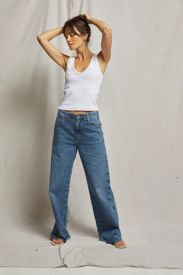 Woman wearing a white ribbed tank top