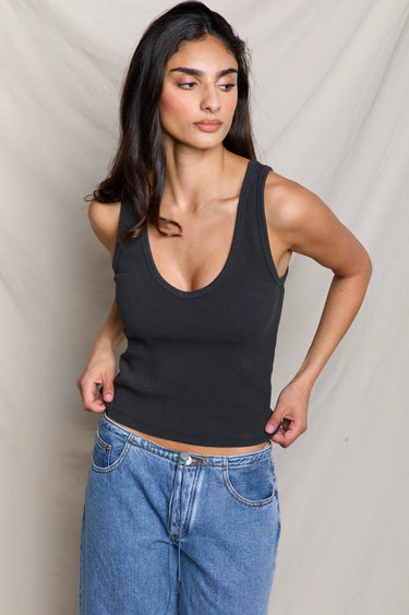 Woman in a black ribbed scoop-neck tank top