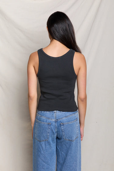 Woman in a black ribbed scoop-neck tank top