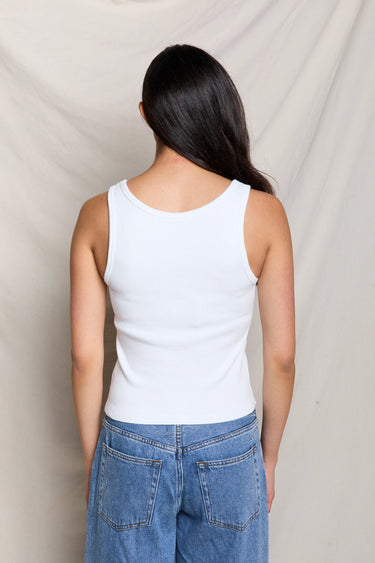 Woman wearing a white ribbed tank top