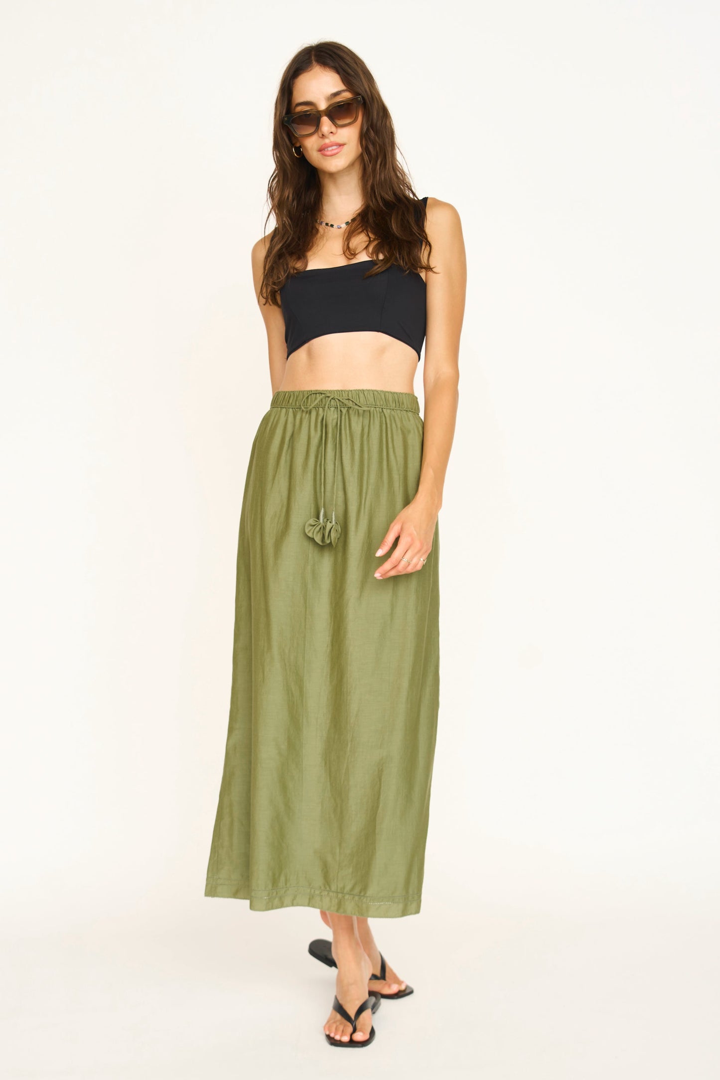 Woman wearing a dill green maxi skirt