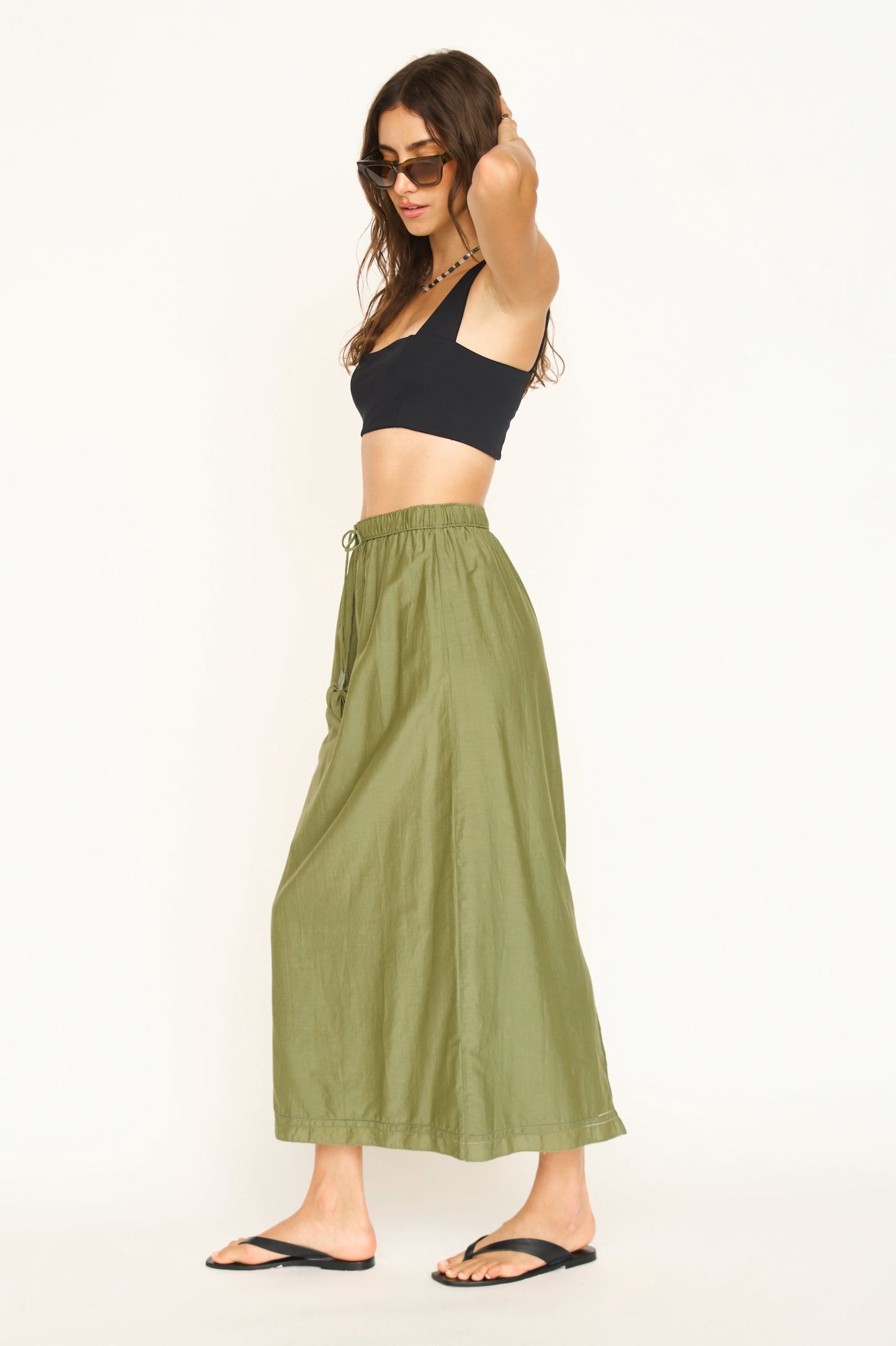 Woman wearing a dill green maxi skirt