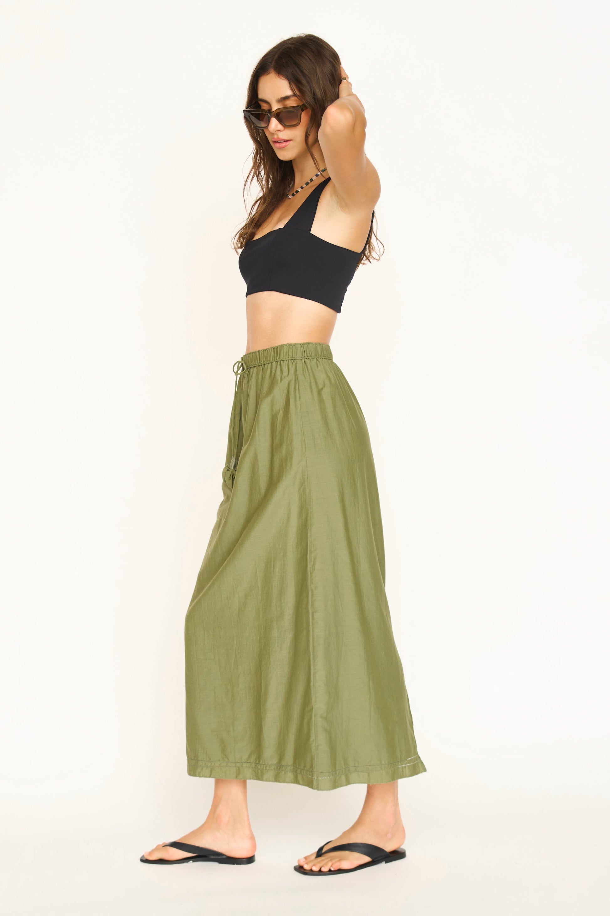 Woman wearing a dill green maxi skirt