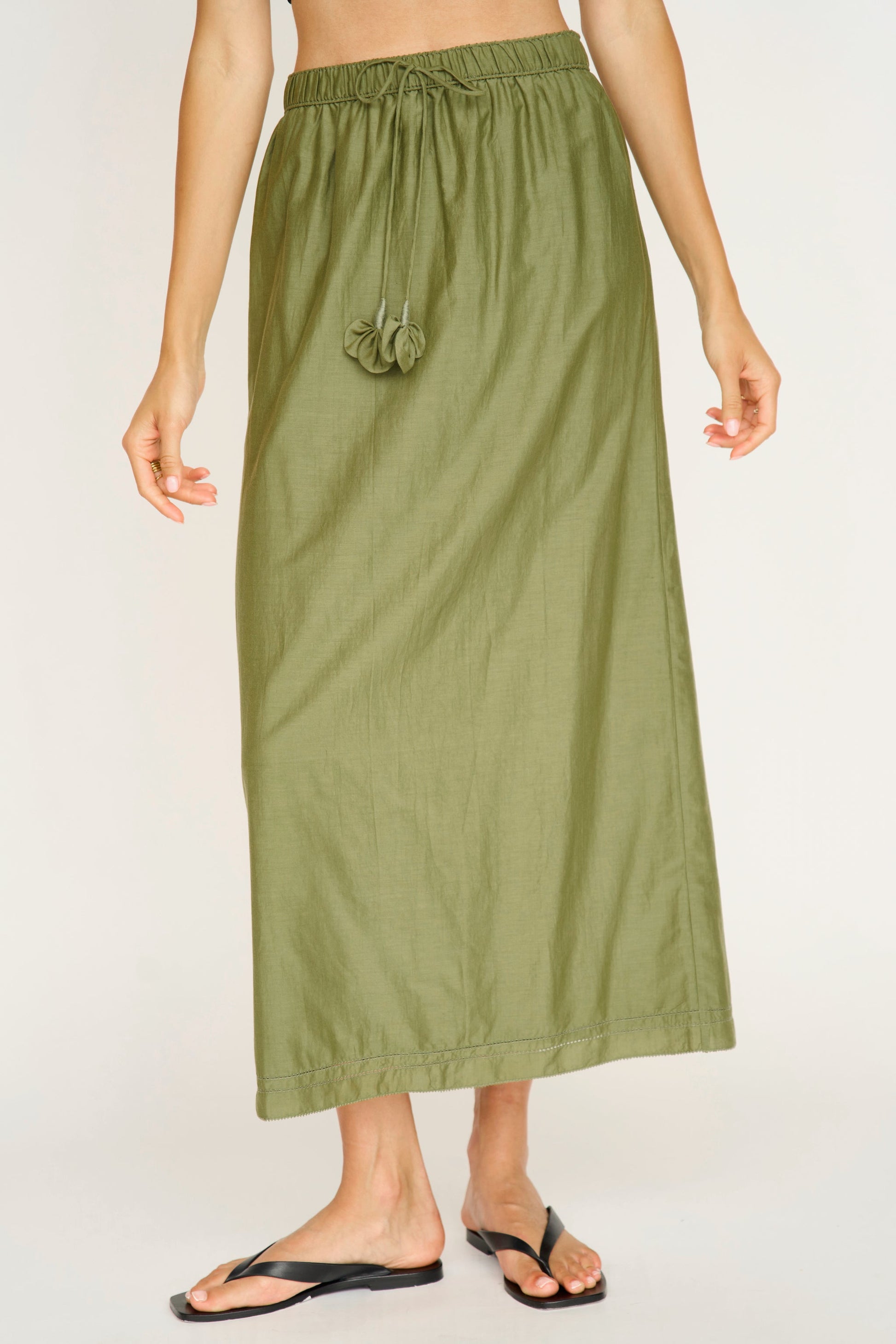 Woman wearing a dill green maxi skirt