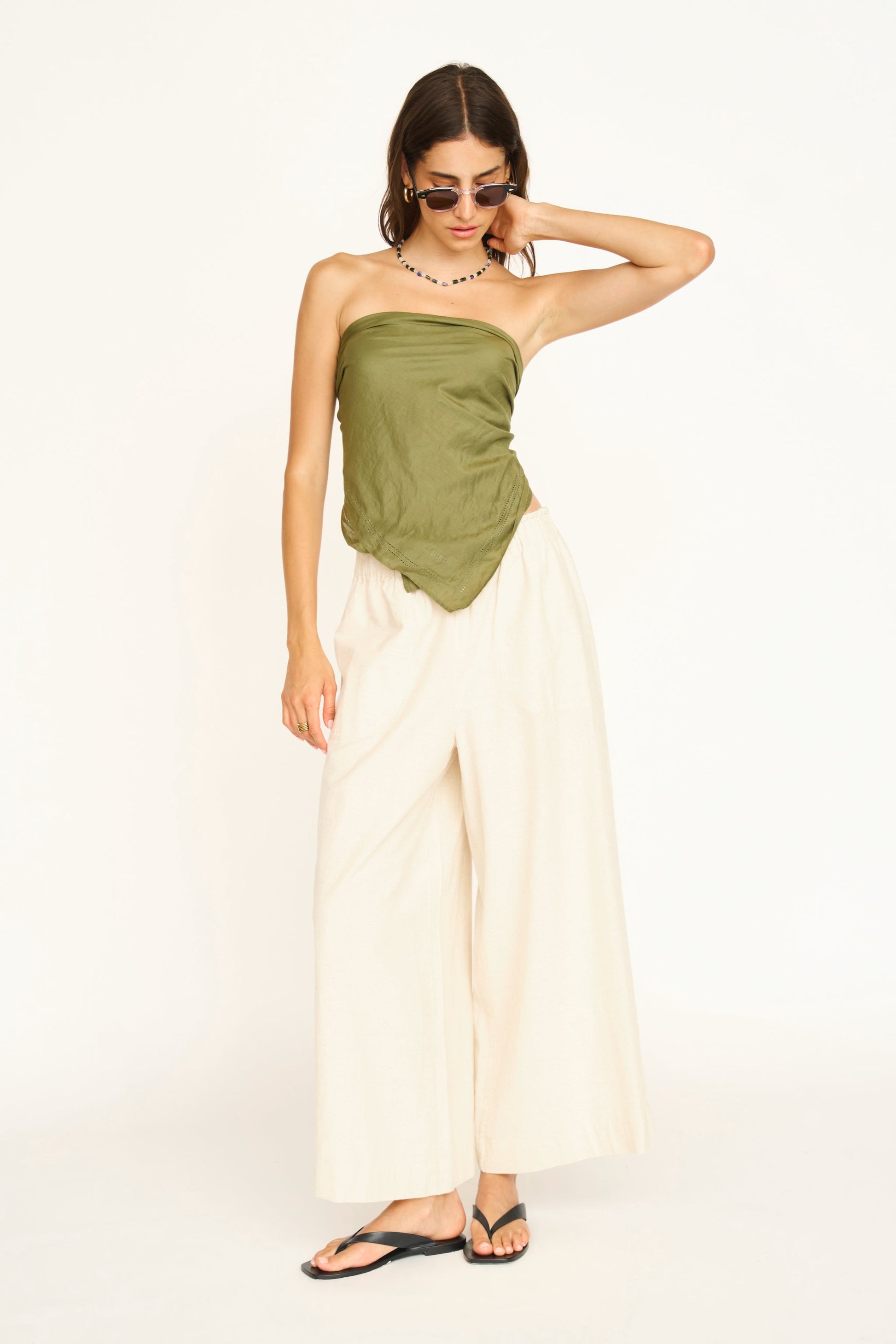 A woman modeling wide-leg cream pants 