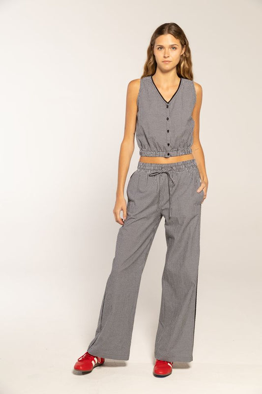 Woman in black gingham button top and pants 