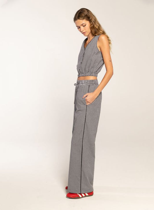 Woman in black gingham button top and pants 