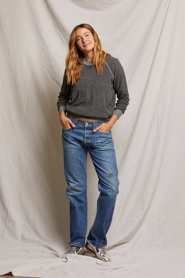Woman wearing a dark heather gray sweatshirt