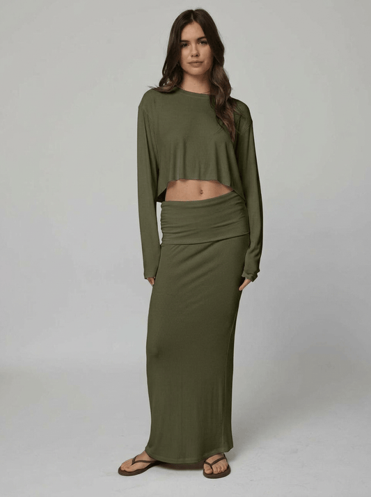 Woman wearing an olive top and skirt
