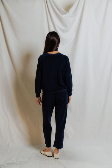 Woman wearing a navy blue sweatshirt