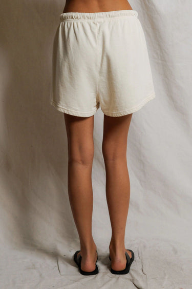 Woman wearing ivory sweat shorts