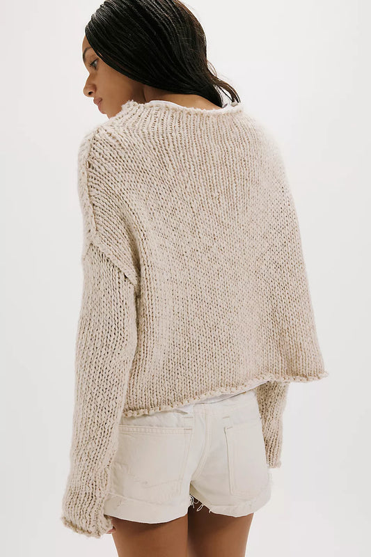 Woman wearing a beige knitted sweater