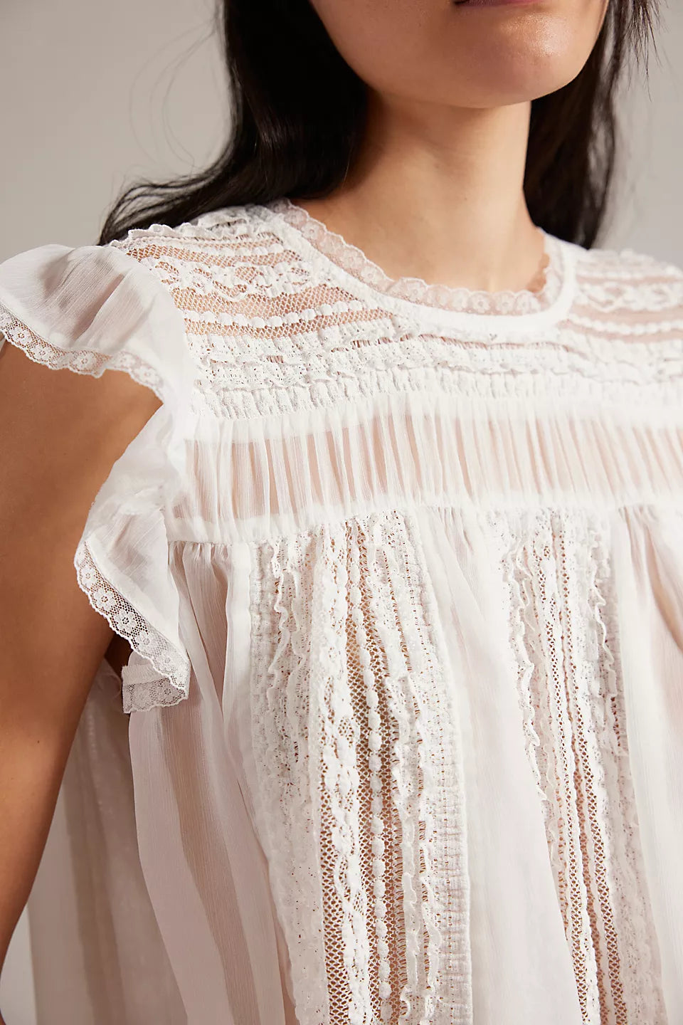 Woman wearing a white lace top 