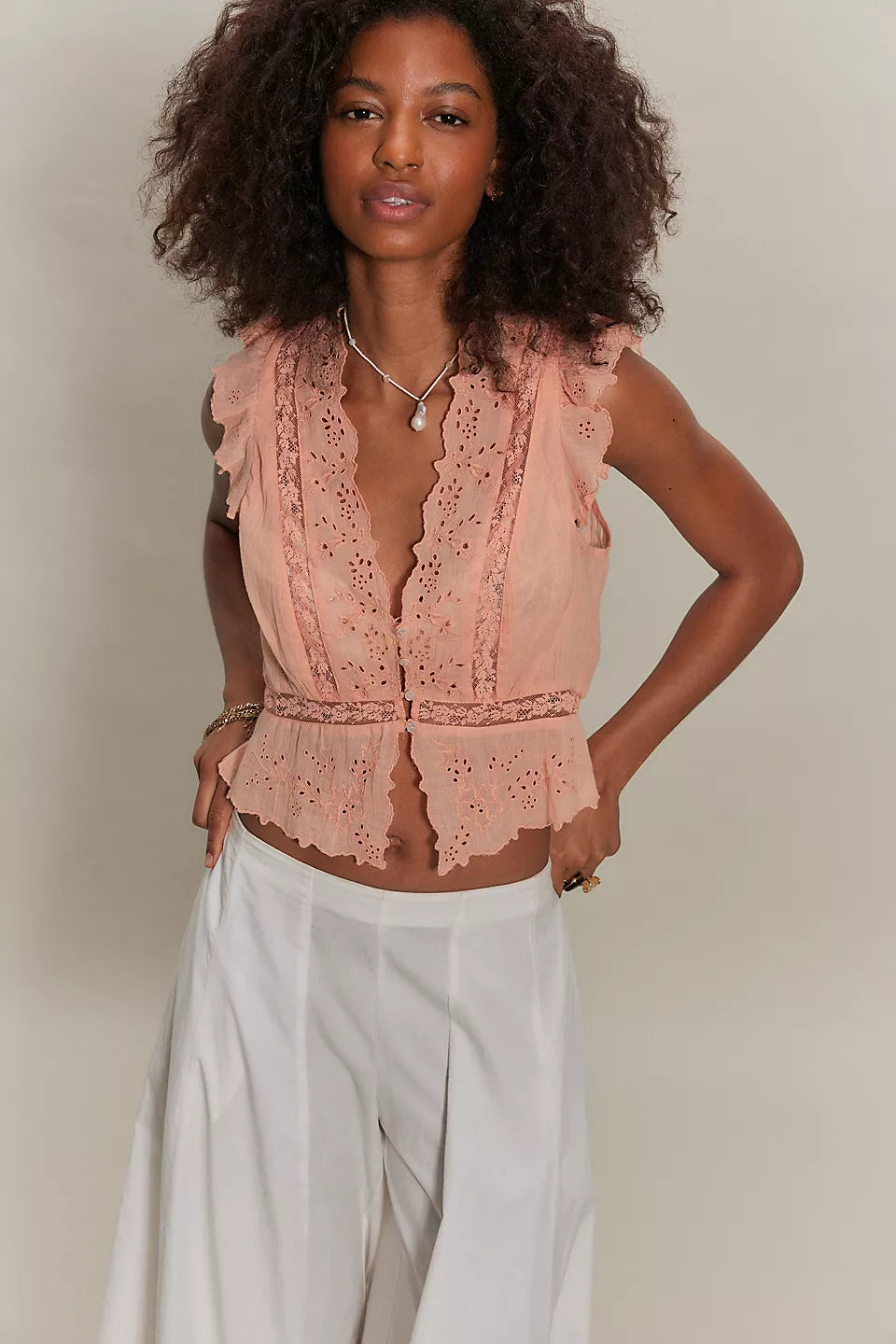 Woman wearing a peach lace top