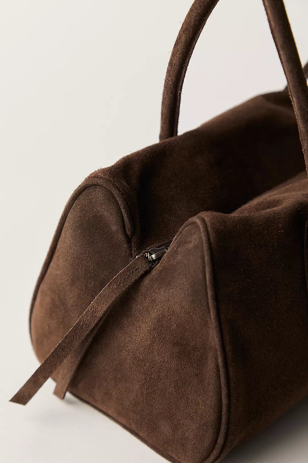 Chocolate brown suede shoulder bag with handles and visible zipper, ideal for everyday carrying needs.
