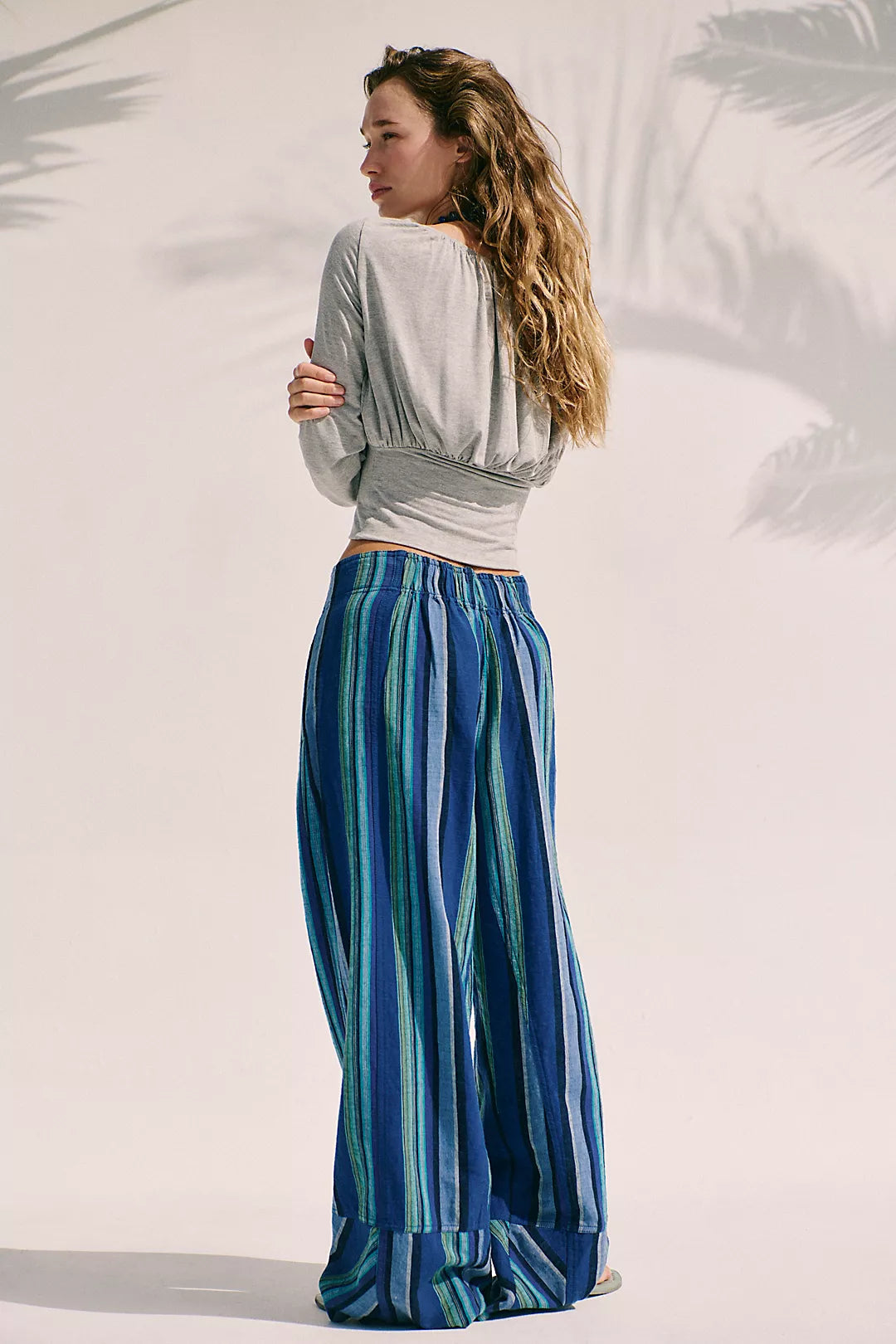Woman wearing navy blue combo striped pants 