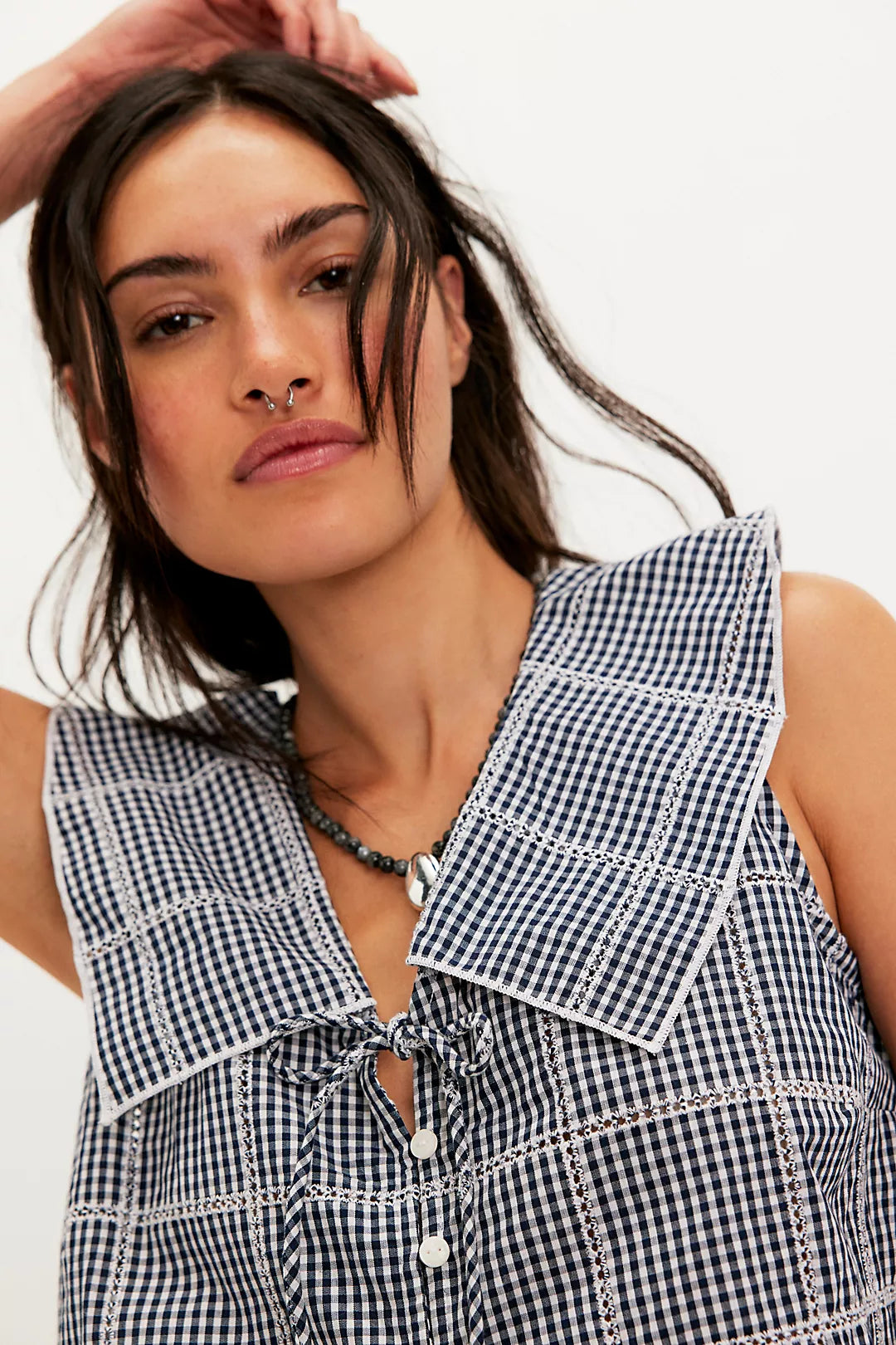 Woman wearing a checkered vest/top
